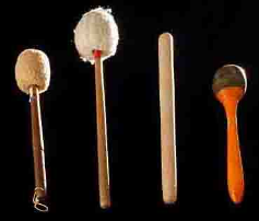 Four drum mallets on a black background, showcasing different bass drum beater types for percussion instruments.