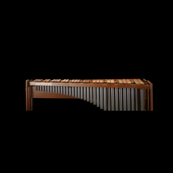 A marimba musical instrument with wooden bars and metal resonator tubes against a black background